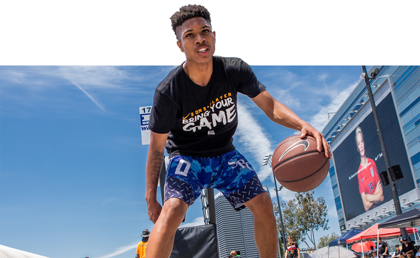 A teen-division player dribbles a basketball at Nike 3-on-3.